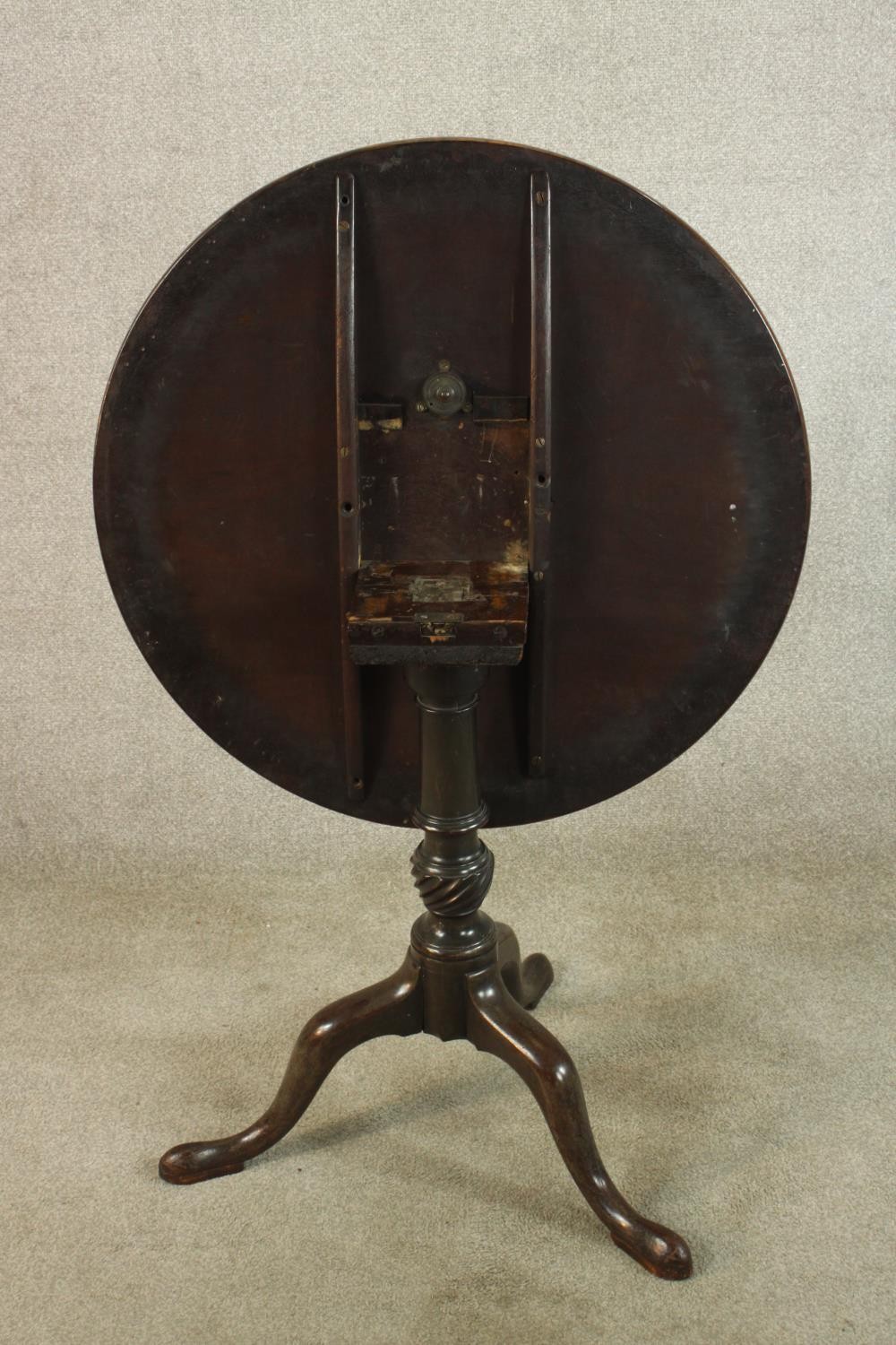 A George III mahogany tilt top tripod table, with turned central column raised on three outswept - Image 6 of 7
