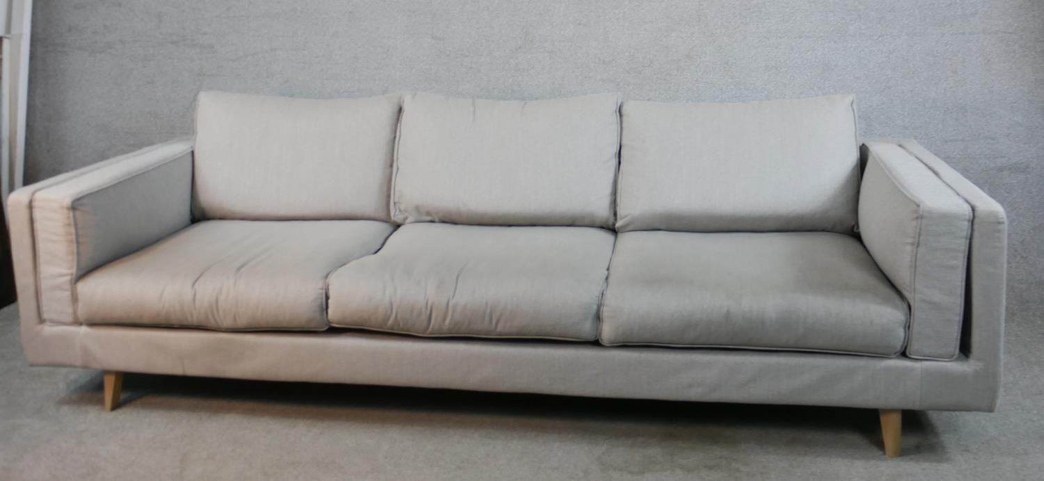 A contemporary three seater Calligaris settee, upholstered in grey fabric raised on shaped beech - Image 2 of 7