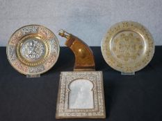 A collection of brass and copper ware including a engraved brass powder flask, a repousse copper,