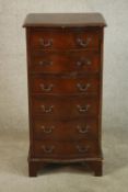 A George III style mahogany sepentine fronted chest of six drawers raised on shaped bracket feet.
