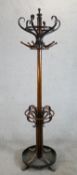 An early 20th century Thonet style bentwood hat, coat and umbrella stand raised on four splayed