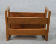 A mid 20th century teak magazine/record rack with twin handles. H.34 W.24 D.22cm