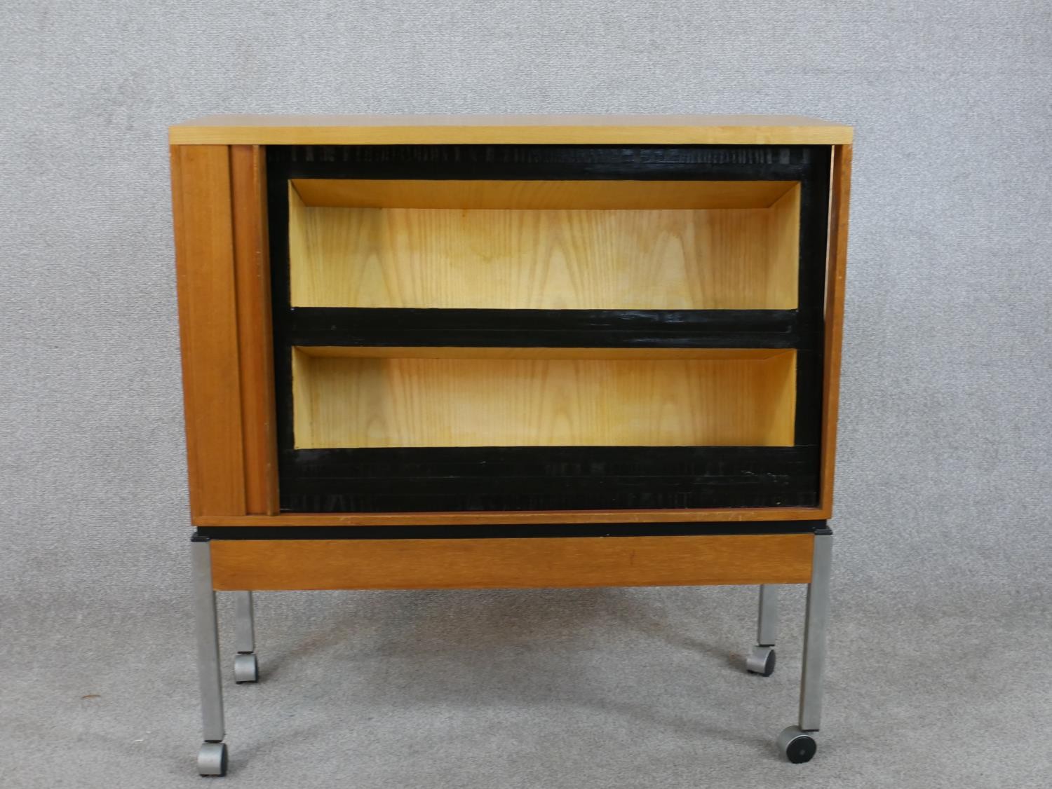 A late 20th century teak tambour fronted cabinet, opening to reveal shelves, raised on square - Image 3 of 6