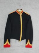 A gold brocade military jacket with shield insignia and star buttons to the epaulettes.