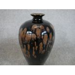 A Chinese pottery baluster shaped vase with oil spot glaze and unglazed foot. H.20 W.36 D.20cm.