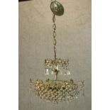 A 20th century cut glass and gilt metal hanging chandelier with spare parts. H.75 Dia.42cm.