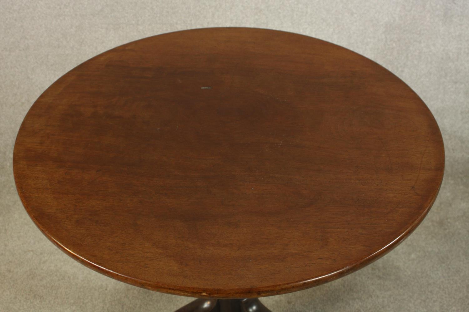 A George III mahogany tilt top tripod table, with turned central column raised on three outswept - Image 3 of 7