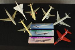 A collection of seven plastic scale model aircraft, including Boeing 767 and Concorde, three with