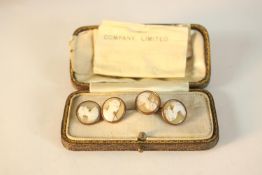 A boxed pair of early 20th century carved shell cameo copper and brass cuff links. Each one with a