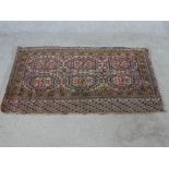 A Tekke Turkmen Juval rug woven with pink and brown fabric. L.73 W.130cm.