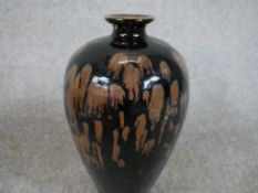 A Chinese pottery baluster shaped vase with oil spot glaze and unglazed foot. H.20 W.36 D.20cm.