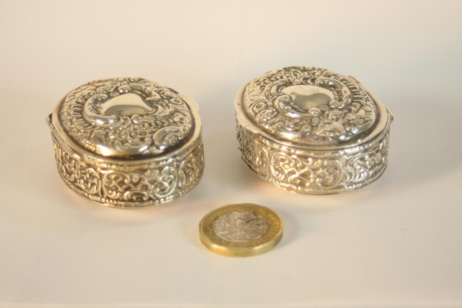 A pair of Edward VII hallmarked silver oval trinket boxes, Birmingham 1902, each with repousse - Image 2 of 6