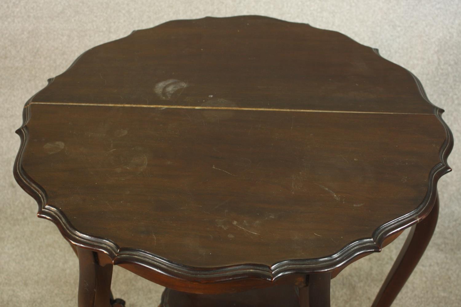 A late Victorian mahogany two tier occasional table, raised on six cabriole supports terminating in - Image 4 of 6