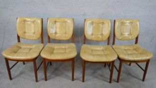 A set of four mid 20th century teak framed and vinyl Meredew button back chairs raised on
