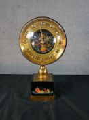 A mid 20th century Russian mantle clock, with hand painted spherical dial and base, decorated with