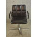 A Walter Knoll design black leather open arm revolving office, raised on four branch chrome plated