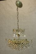 A 20th century cut glass and gilt metal hanging chandelier with spare parts. H.75 Dia.42cm.