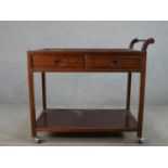 A mid 20th century Chinese hardwood, (possibly cherrywood), two drawer trolley with shelf below,