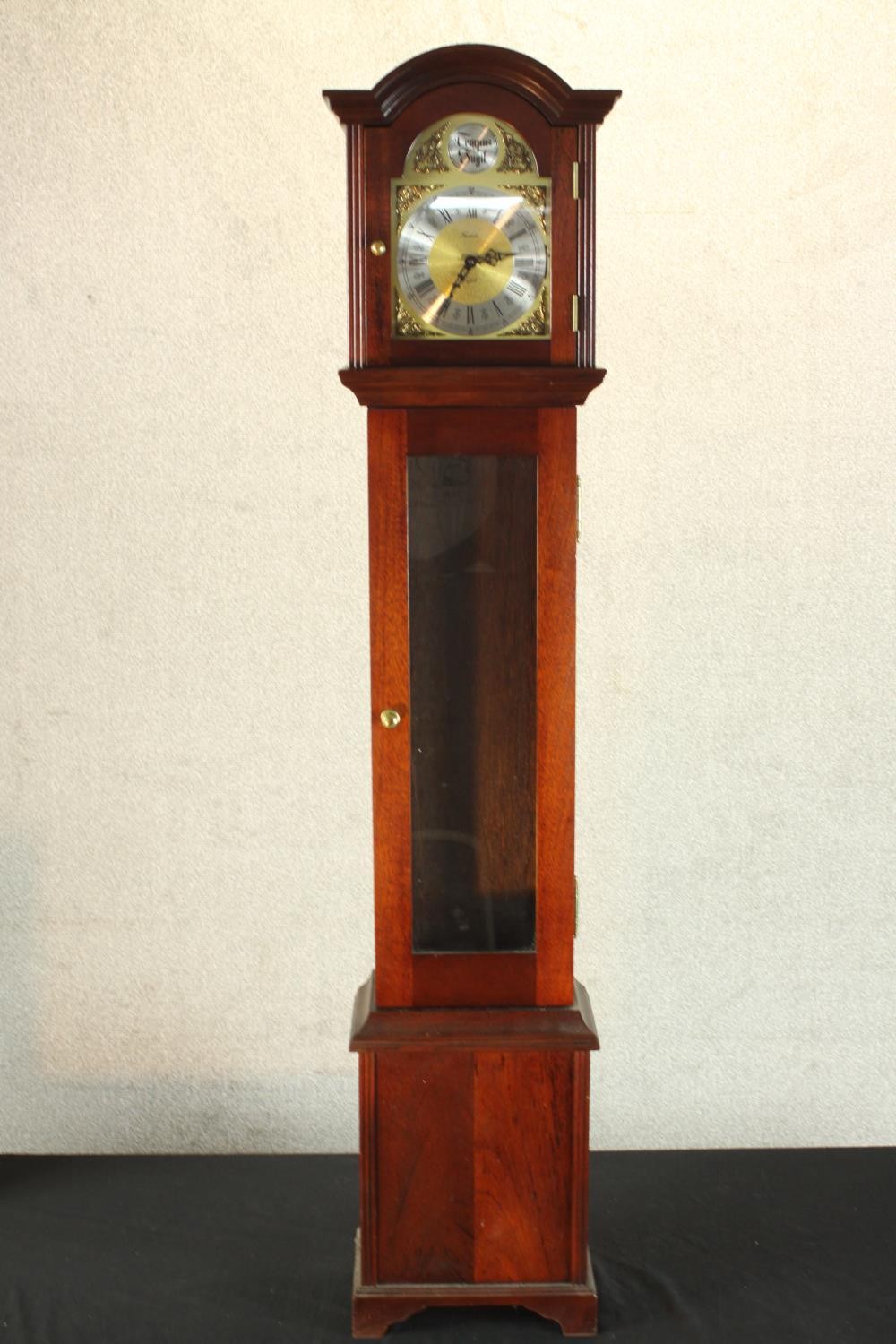 A 20th century mahogany cased Tempus Fugit grandmother clock, the brass and silvered dial with