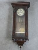 A late 19th / early 20th century oak cased regulator style wall clock, the white dial with black