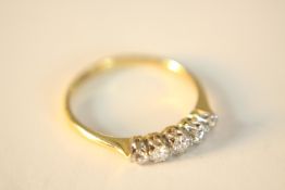 An 18ct yellow gold and platinum five stone graduated old cut diamond ring. Set with five round