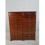 An early 20th century mahogany collectors chest of twenty two drawers, comprising of two banks of