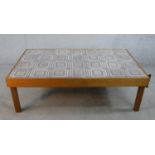 A mid 20th century rectangular teak framed tile topped coffee table raised on square supports. H.