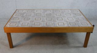 A mid 20th century rectangular teak framed tile topped coffee table raised on square supports. H.