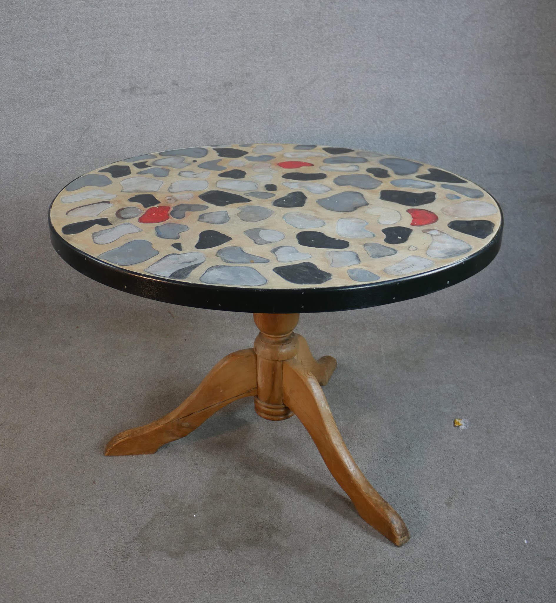 A 20th century circular table, with painted mosaic effect top raised on turned central pine column