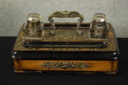 A 19th century walnut, ebony and brass two bottle desk standish, with carrying handle and central