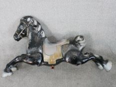 A 20th century painted aluminium fairground carousel horse, with articulated limbs. H.54 W.95 D.