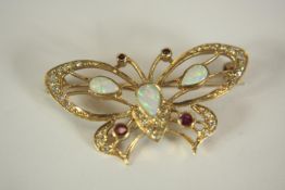 A 9ct yellow gold, opal, diamond and ruby openwork butterfly brooch. The brooch set with three