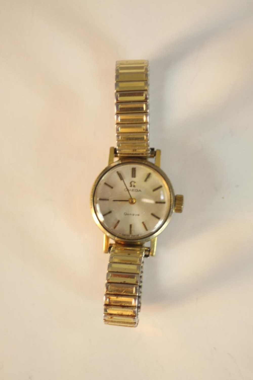 A ladies gold plated Omega Geneve automatic wrist watch with baton numerals and applied hands on