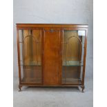 An early 20th century Georgian style twin door mahogany display cabinet; with glass astragal