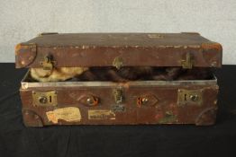 A vintage leather suitcase full of various types of fur, including mink, rabbit and fox, two mink