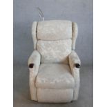 A contemporary grey fabric upholstered electric reclining armchair with integral reading light (in