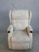 A contemporary grey fabric upholstered electric reclining armchair with integral reading light (in