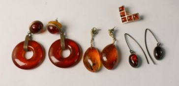 A collection of amber and silver jewellery, including three pairs of silver an amber drop earrings