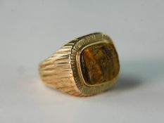 A textured bark effect 9 carat yellow gold signet ring, inset with a rough cut tigers eye. Ring size