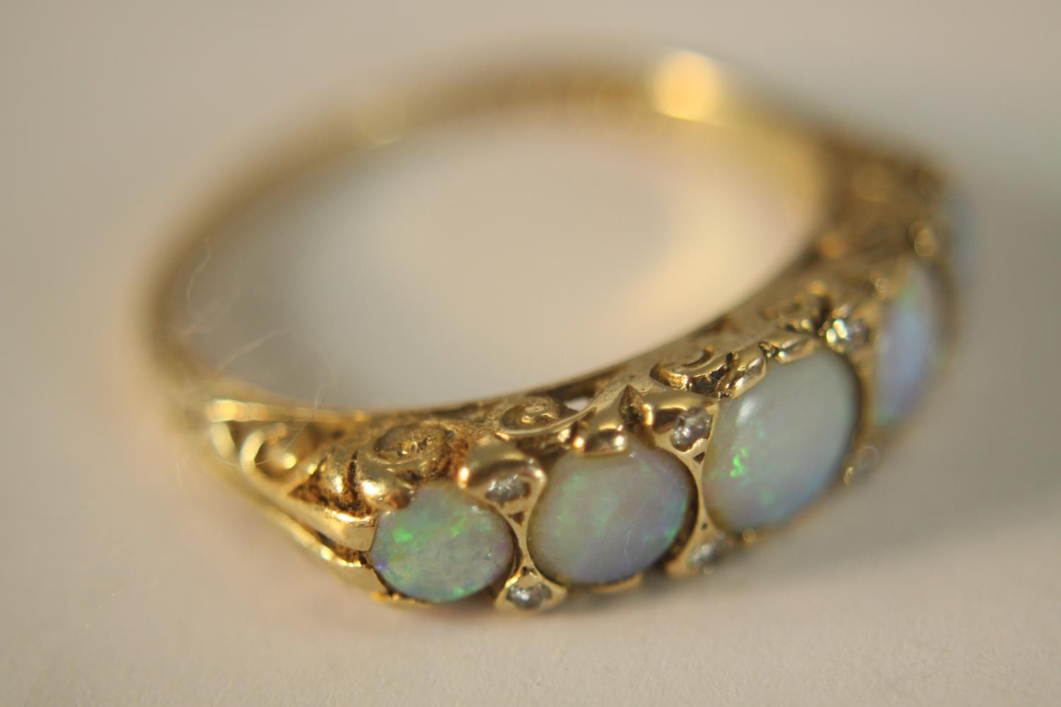 A 9ct carat yellow gold carved half hoop five stone Opal and diamond ring. Set with five round - Image 3 of 10