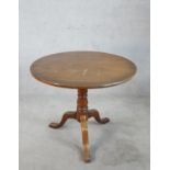 A 19th century mahogany tilt top tripod table, with turned baluster central raised on three outswept