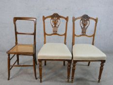 A pair of late 19th century walnut framed pierced splat back chairs, with stuff over seats, raised