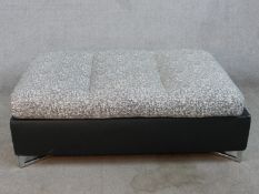 A contemporary Ligne Roset button seat grey upholstered foot stool, raised on chrome plated supports