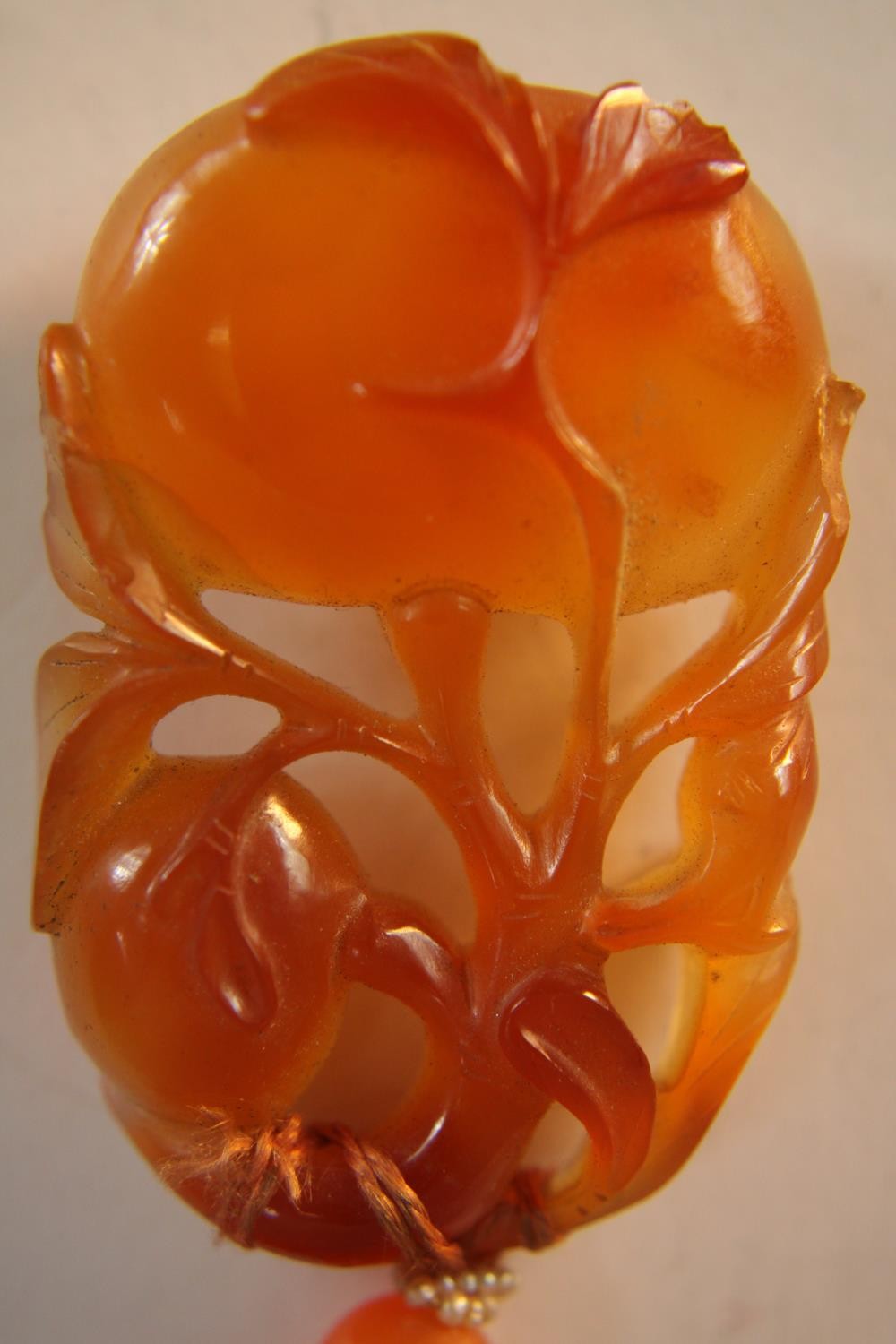 An early 20th century Chinese carved carnelian necklace, the carved pendant in the form of two - Image 5 of 8