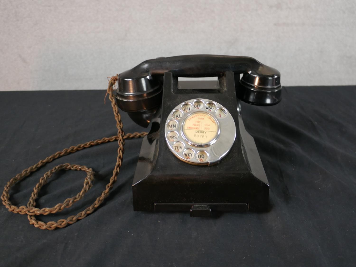 A 1930s/1940s black Bakelite GPO telephone, with white metal dial and drawer. H.14 W.15 D.20cm