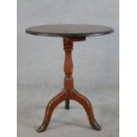 A 19th/early 20th century mahogany and pine tripod table, with turned central column raised on three