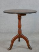 A 19th/early 20th century mahogany and pine tripod table, with turned central column raised on three