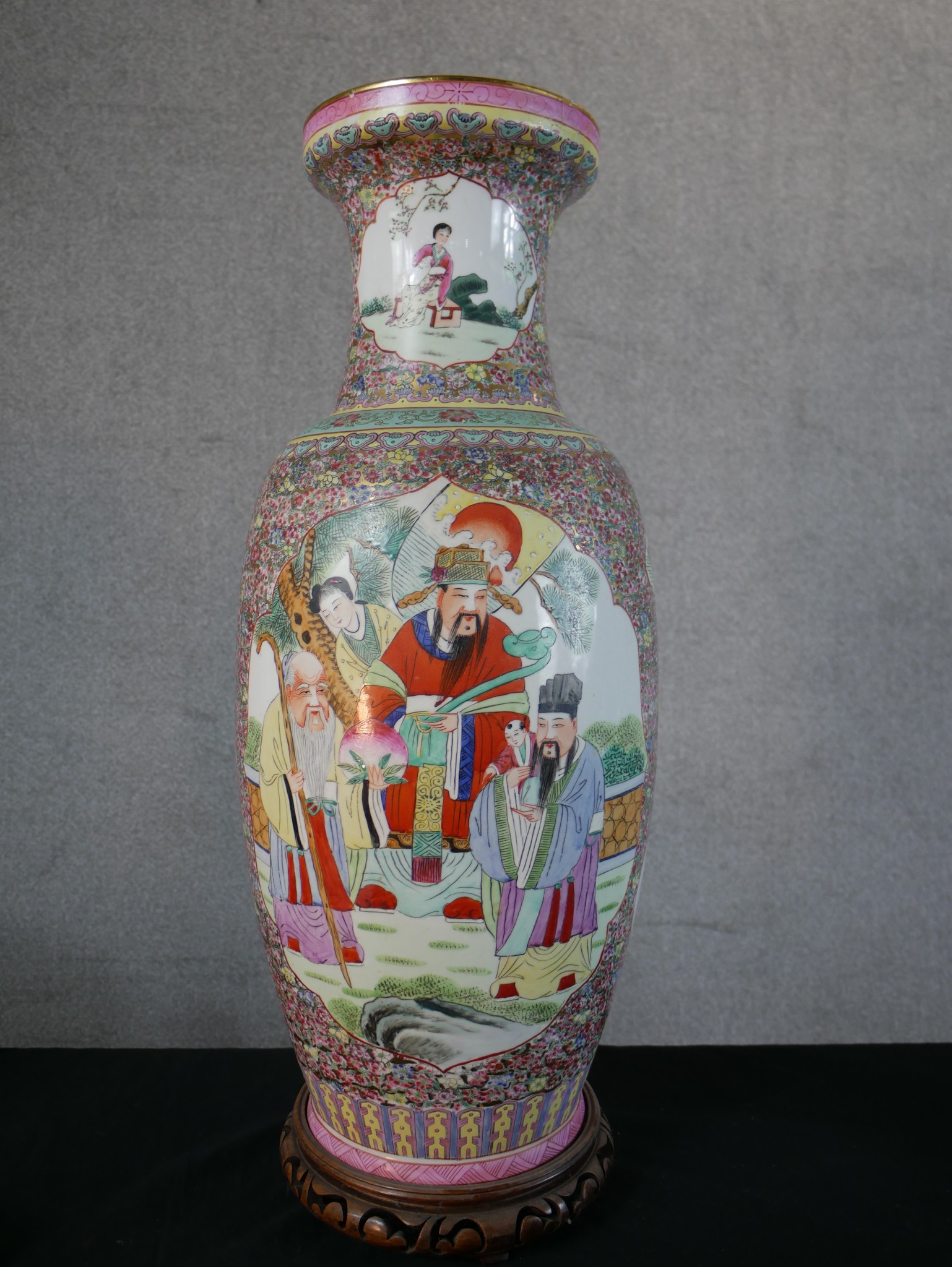 A Chinese porcelain baluster shaped vase decorated with panels of figures in a garden within