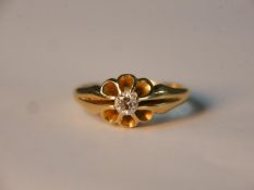 A yellow metal (tests as 18ct) diamond set floral design carved ring. Set to centre with a round old