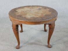 A 19th / early 20th century circular beech and pokerwork occasional table, raised on cabriole legs